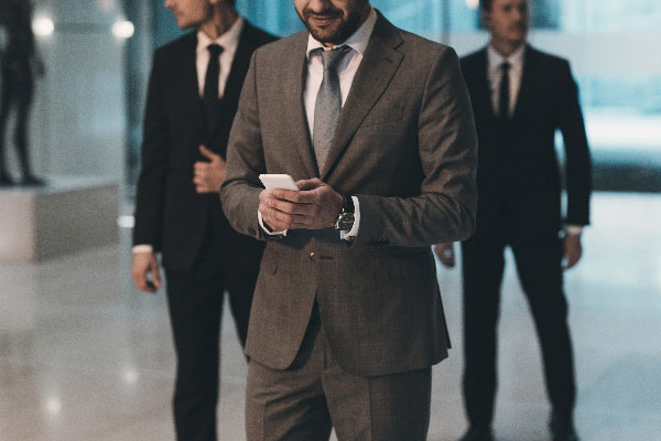cropped-image-of-businessman-looking-at-smartphone-XY6WQB9